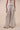 The Nori trousers are an elastic waisted 100% linen pant for a comfortable easy fit, with finishing including real natural pearl and gold plated charms at the end of the belt ties.  Embroidery designed by Fleur Kakasi at the hem. 